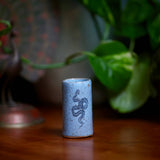 Tiny blue speckled tumbler featuring a coiled snake illustration.