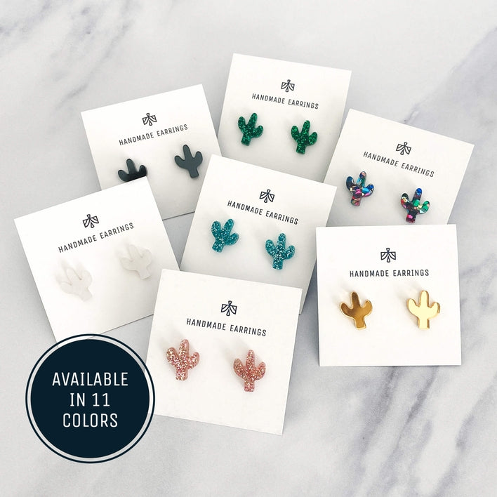 Assorted glittery cactus acrylic stud earrings displayed on white cards.