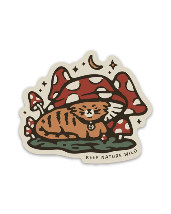 Tabby cat curled beneath oversized red and white mushrooms in a whimsical sticker