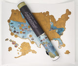 63 US National Park scratch-off map rolled over a printed United States map.