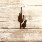 Quail and saguaro rustic metal magnet on weathered wood background.