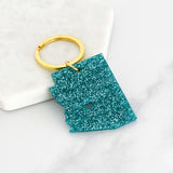 Acrylic Arizona keyring in teal glitter with a gold ring and heart cutout