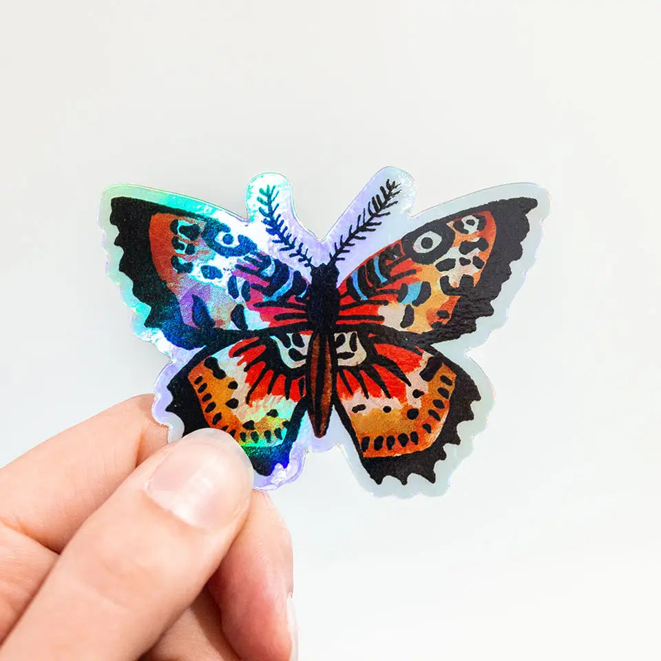Held holographic butterfly sticker with multicolored iridescent wings