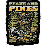 Peaks and Pines sticker with an outdoor scene of mountains and pine trees