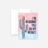 Hug You In My Heart greeting card with watercolor cactus designs on a pink and blue background