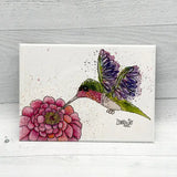 Watercolor hummingbird magnet with a pink bloom on a white background