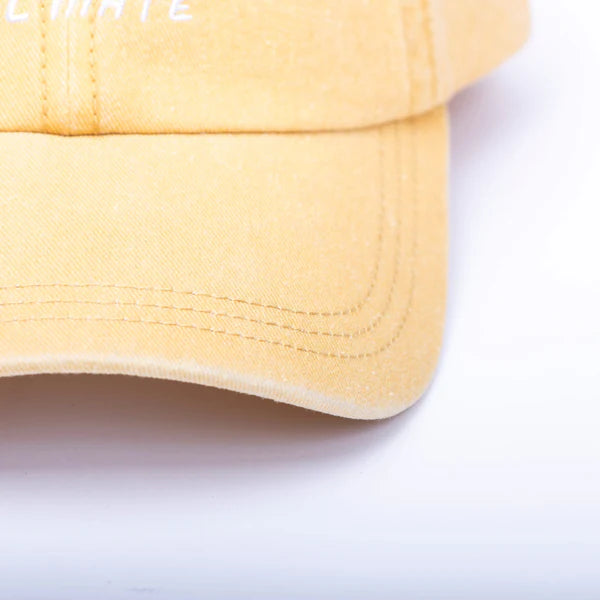 Close up of the mustard Sol Mate dad hat brim with detailed stitching
