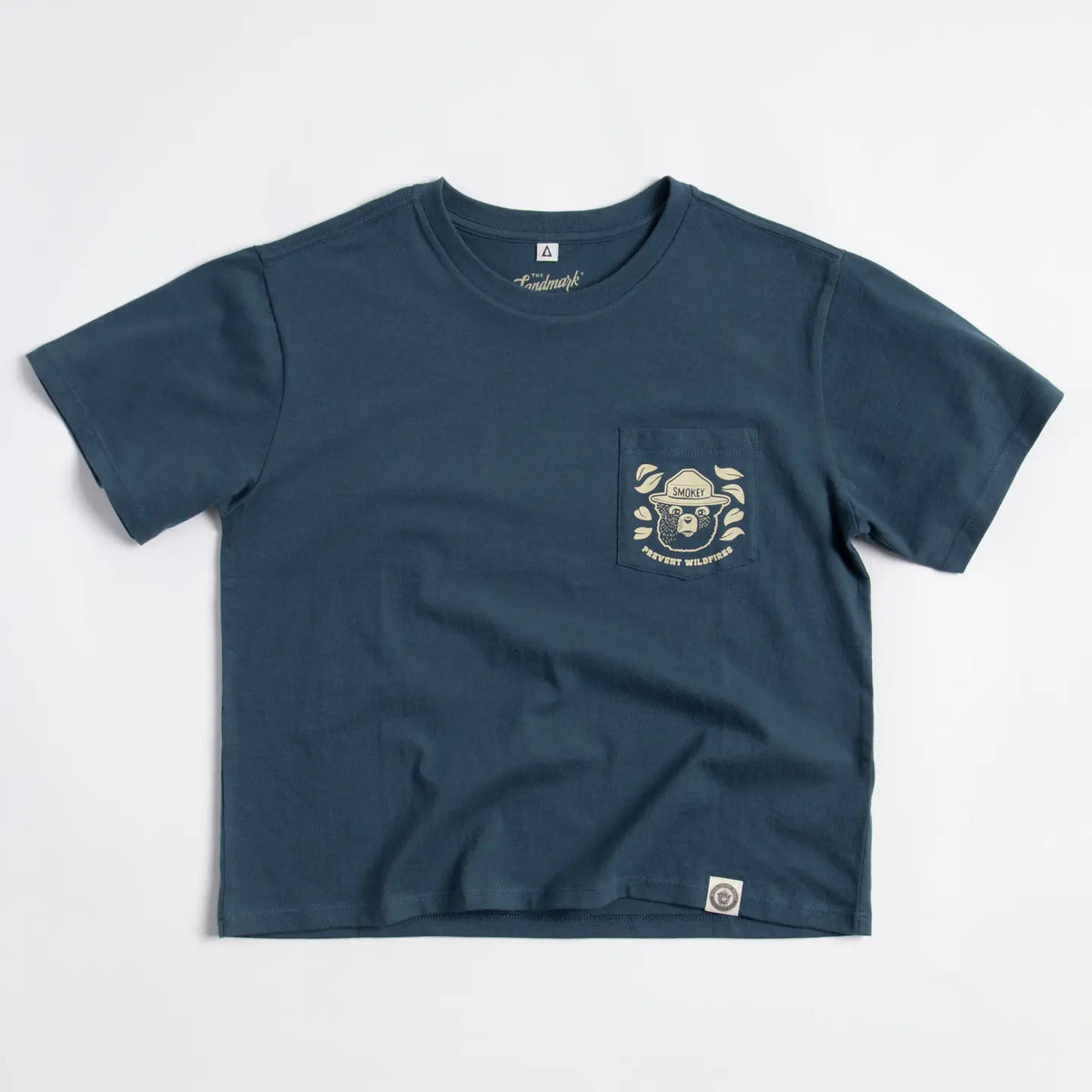 Navy blue boxy cropped tee with a front pocket featuring Smokey Bear and forest scene.