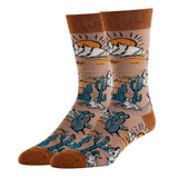 Pair of Wild West themed men's socks with mountains and cacti on a tan background