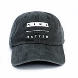 Black dad hat with white Mind Over Matter embroidery on the front