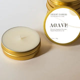 Agave scented mini travel candle with white label on a gold tin.
