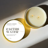 Cactus Water scented candle in a gold tin with a white label that reads CACTUS WATER.