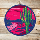 Round Saguaros at Sunset sticker with a pink sky, neon green cacti, and a dark blue rim.