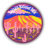 Circular Saguaro National Park sticker with a vibrant desert landscape and pink cacti.