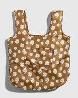 The Packable Tote in brown with white floral print and shoulder straps