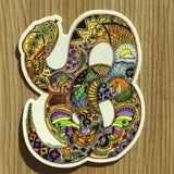 Colorful mosaic snake sticker with intricate patterns and bold hues