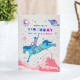 Space Cowboy Holographic Birthday Card featuring a space cowboy riding a horse through a cosmic scene with rainbow text.