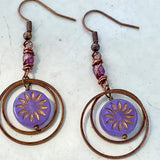 Copper hoop earrings with purple sunburst discs and wrapped copper accents