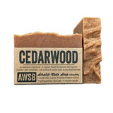 Cedarwood soap bar with bold CEDARWOOD label and a tall bar behind it.