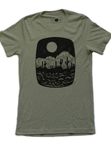 Olive Night Butte tee featuring a black desert landscape graphic with a moon and cacti