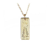 Gold fill pendant necklace with a vertical rectangle showing a pine tree and a night sky with stars and a crescent moon