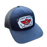 Navy curved brim trucker hat with mesh back and a rectangular patch reading Iconic Arizona The Desert Bites Back.