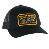 Black desert drifter trucker hat with a yellow embroidered patch reading Desert Drifter Iconic Arizona