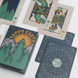 Tree themed playing cards spread with forest illustrations and a matching card box