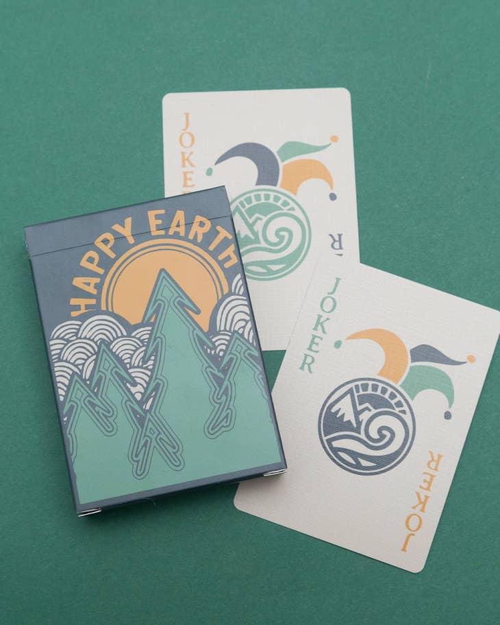 Tree Playing Cards deck with mountain illustrations on a green background.
