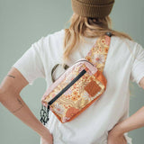 Everyday Fanny Pack Bloom with floral pattern worn crossbody over a white t shirt