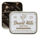 Desert Hills Motel incense cones in an open metal tin with a pale label