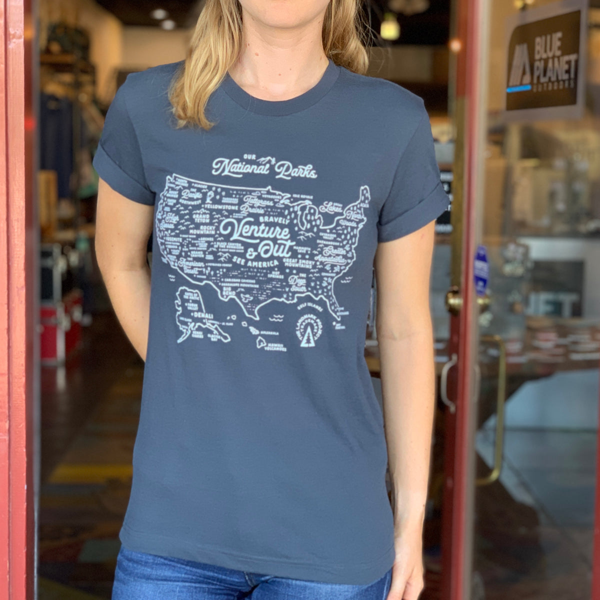 Person wearing deep navy National Parks Map Tee with a white map graphic