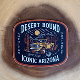 Desert Bound sticker edge with bold white letters on a dark background and orange border.